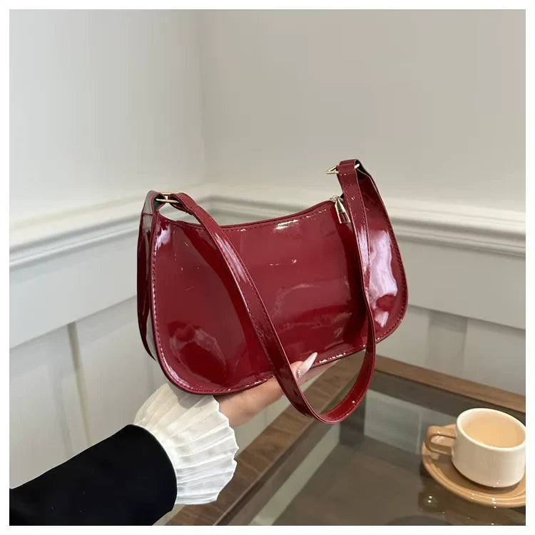 Sac à main SYA petit format vernis rouge, design raffiné et lumineux, idéal pour transporter vos essentiels avec style lors de vos sorties